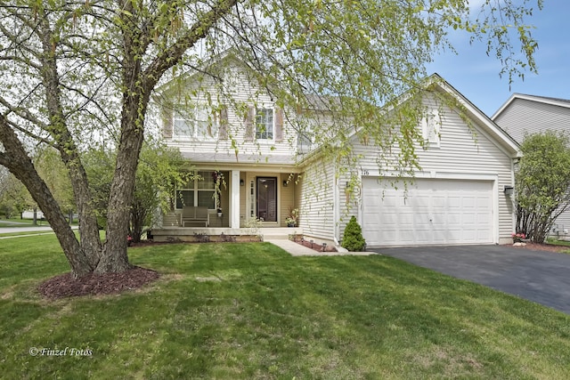 view of property featuring a porch, a garage, and a front yard