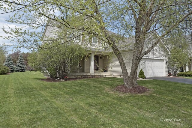 view of front of house featuring a garage and a front lawn