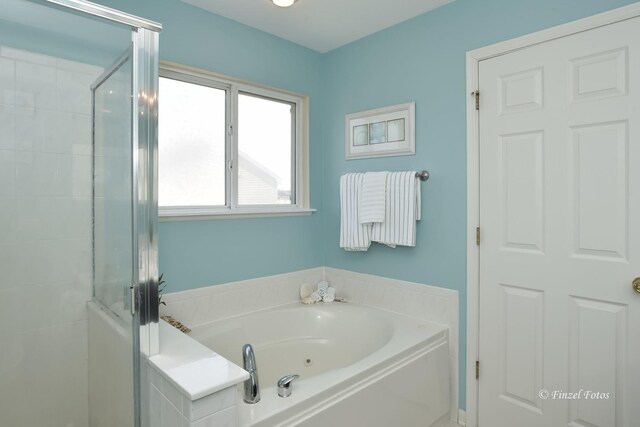 bathroom with shower with separate bathtub