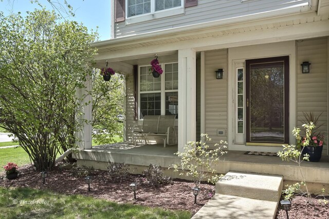 view of exterior entry featuring a porch