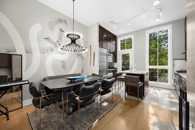 dining area featuring light hardwood / wood-style floors and a chandelier