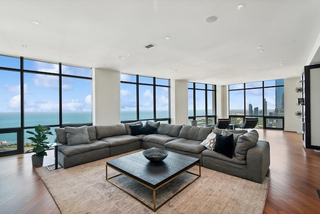 living room with a water view and hardwood / wood-style flooring