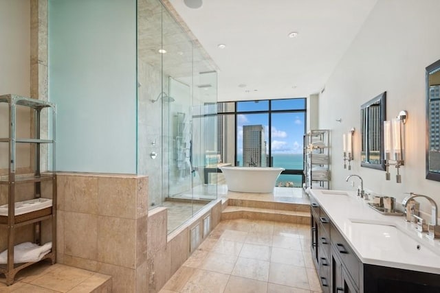 bathroom featuring tile patterned floors, floor to ceiling windows, vanity, and independent shower and bath