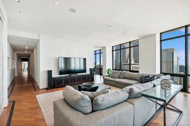 living room featuring expansive windows and light hardwood / wood-style flooring