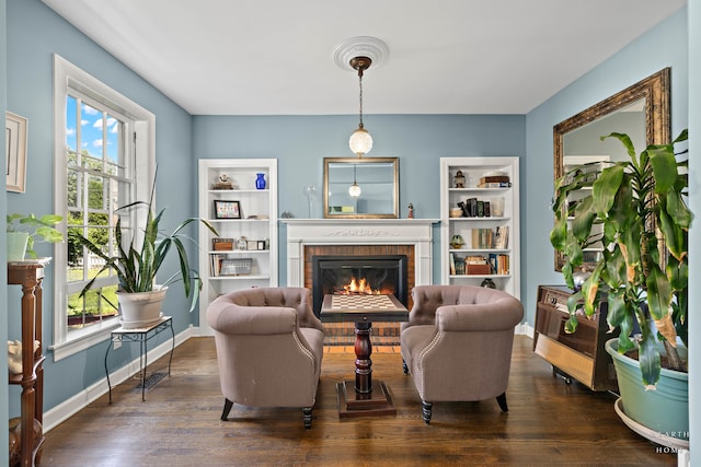 interior space with dark hardwood / wood-style flooring and a brick fireplace