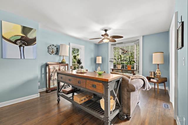 living room with ceiling fan and dark hardwood / wood-style flooring