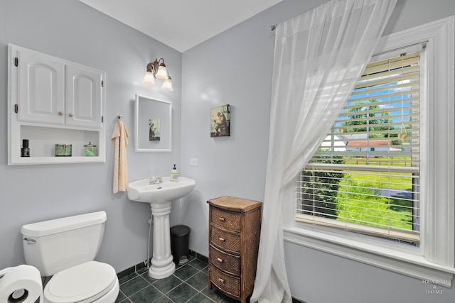 bathroom featuring tile patterned flooring and toilet