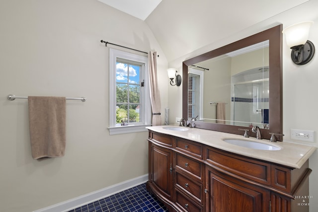 bathroom featuring vanity, vaulted ceiling, walk in shower, and tile patterned floors