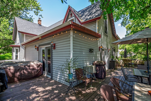 deck with french doors and an outdoor hot tub