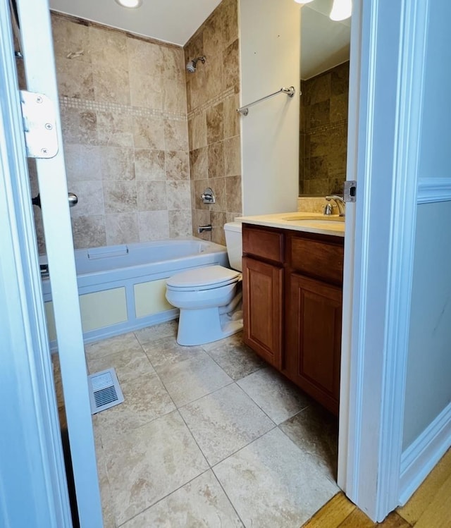 full bathroom featuring vanity, toilet, and tiled shower / bath