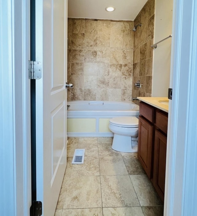 full bathroom with vanity, toilet, and tiled shower / bath