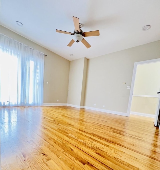 empty room featuring ceiling fan and light hardwood / wood-style floors