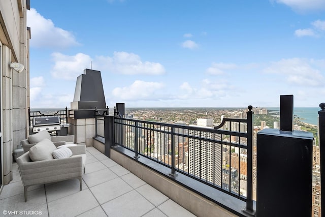 balcony with a water view and grilling area