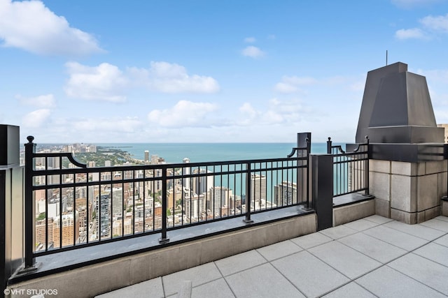 view of patio featuring a balcony and a water view