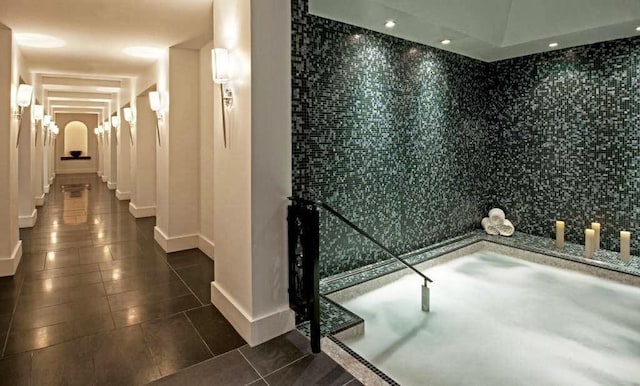 bathroom with tile walls and tile patterned floors