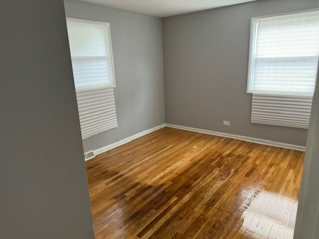 empty room with wood-type flooring