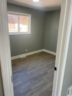 unfurnished room featuring dark wood-type flooring