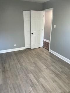 unfurnished bedroom featuring hardwood / wood-style flooring