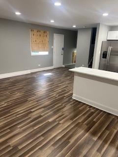 unfurnished living room featuring dark hardwood / wood-style floors