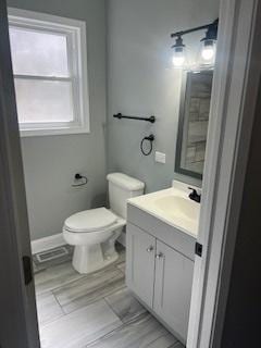 bathroom featuring toilet and vanity