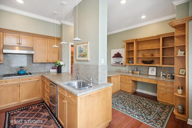 kitchen with under cabinet range hood, a peninsula, a sink, built in desk, and pendant lighting