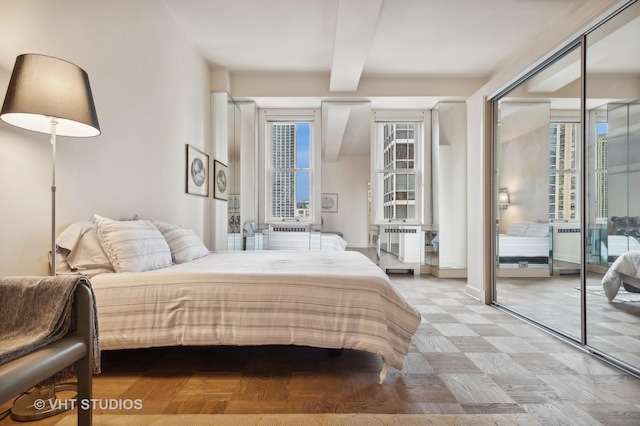 bedroom with a closet and beam ceiling