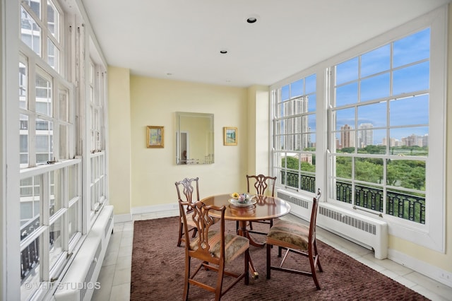 dining room with light tile patterned flooring and radiator heating unit