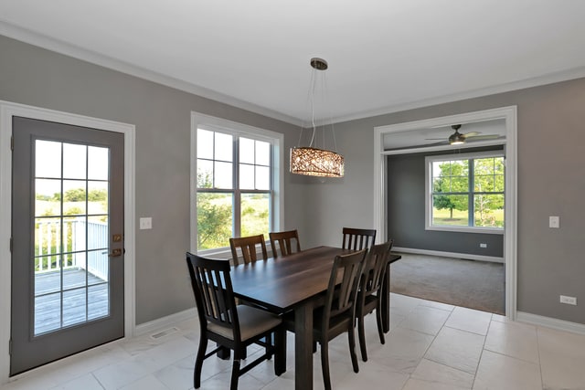 dining space featuring light tile patterned floors and ceiling fan