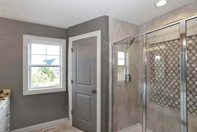 bathroom featuring vanity and an enclosed shower