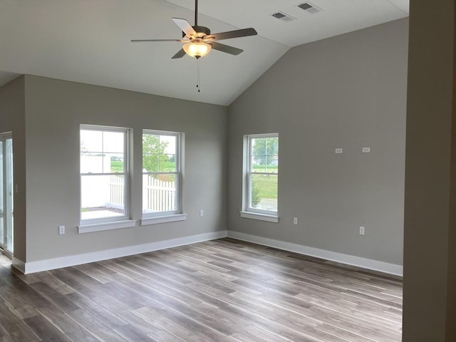 unfurnished room with hardwood / wood-style flooring, ceiling fan, lofted ceiling, and a wealth of natural light