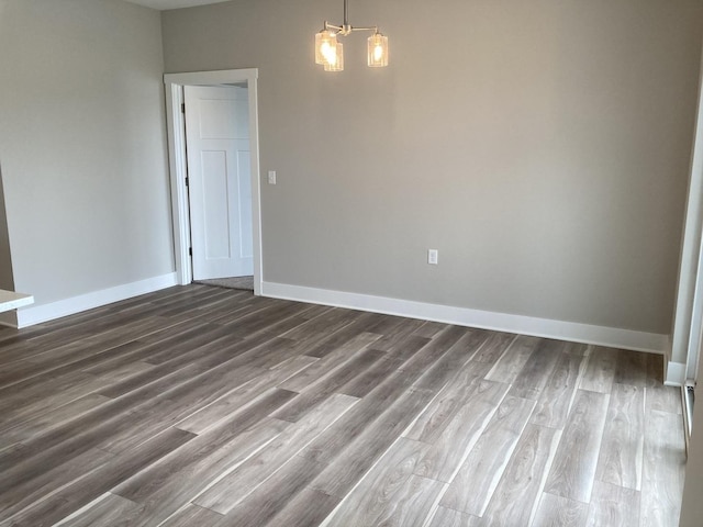 spare room with dark wood-type flooring