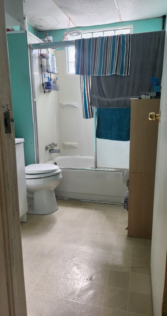 bathroom with shower / tub combination and toilet