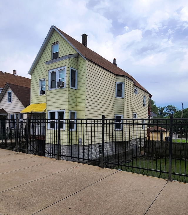 view of side of home with a lawn and cooling unit