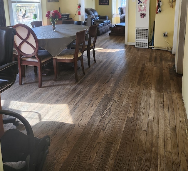 dining area featuring dark wood-type flooring