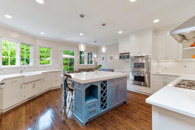 kitchen with white cabinetry, a center island, sink, and appliances with stainless steel finishes