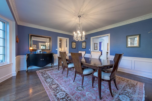 dining space with plenty of natural light, crown molding, and dark wood-type flooring