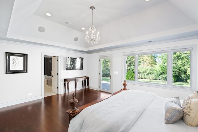 bedroom with access to exterior, a tray ceiling, recessed lighting, an inviting chandelier, and wood finished floors