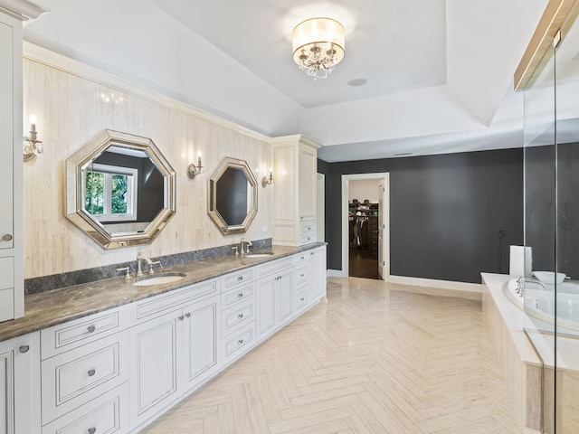 full bathroom with a tub to relax in, a walk in closet, a sink, and double vanity