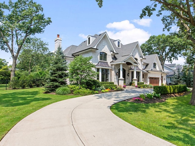 view of front of property with driveway, a garage, and a front lawn