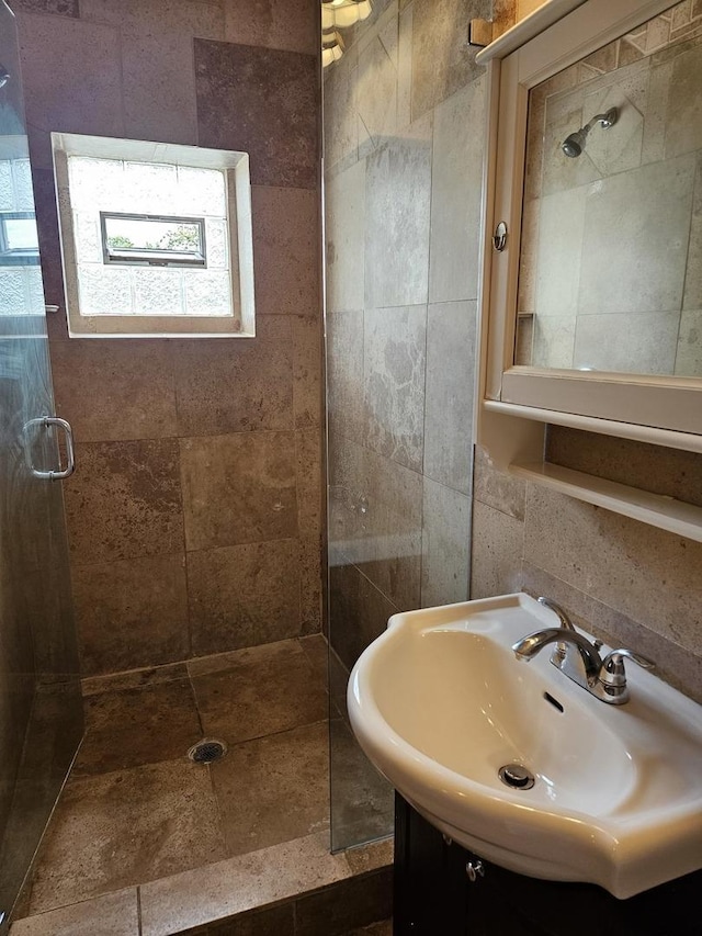 bathroom with an enclosed shower and sink