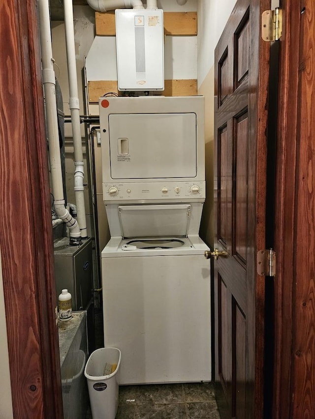 clothes washing area with stacked washer / drying machine