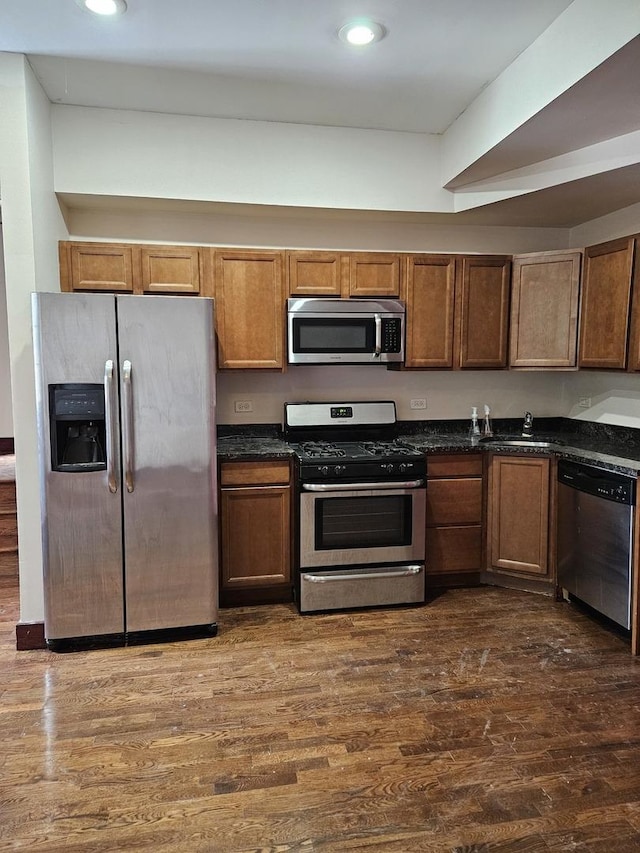 kitchen featuring dark wood-type flooring and stainless steel appliances