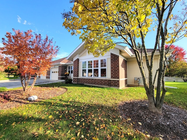 view of front facade with a garage and a front lawn