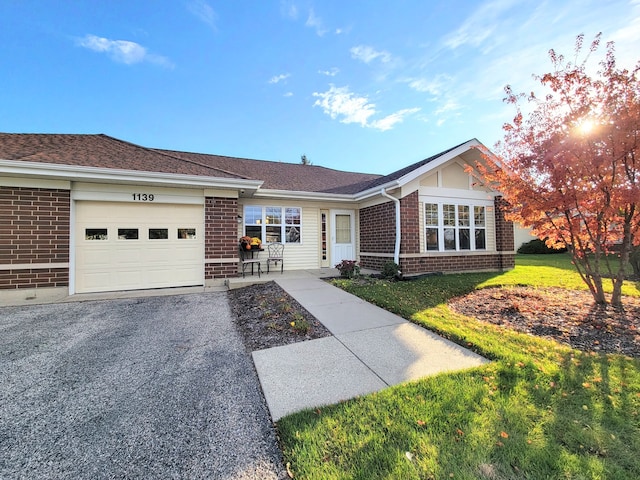 ranch-style home with a garage and a front yard