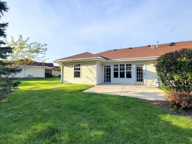 rear view of house featuring a patio and a lawn