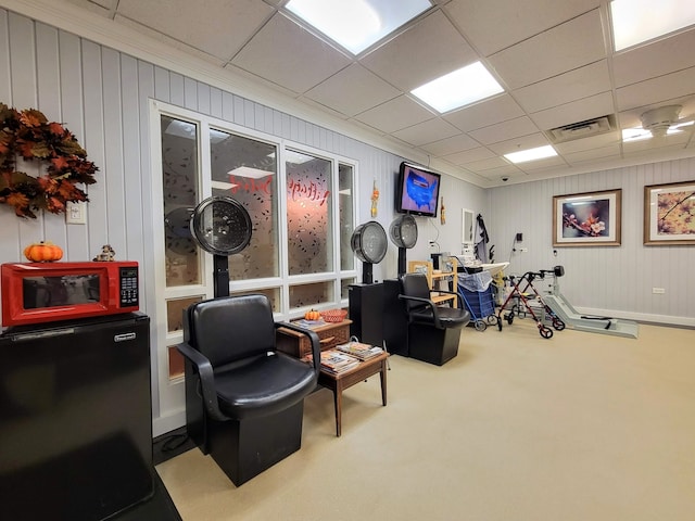 interior space featuring carpet and a paneled ceiling