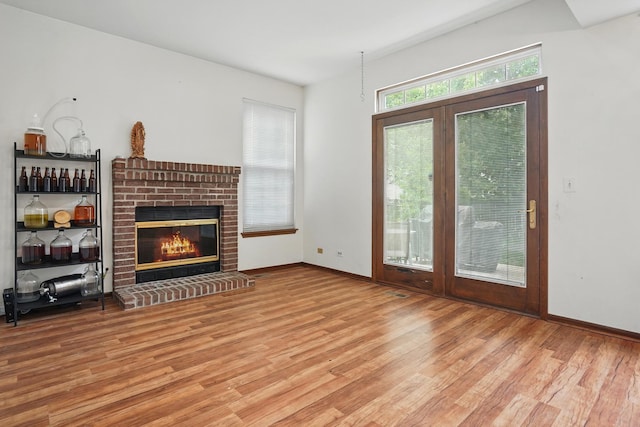 1406 Trescott St, Mundelein, IL 60060 - unfurnished living room featuring wood finished floors, a fireplace, and baseboards