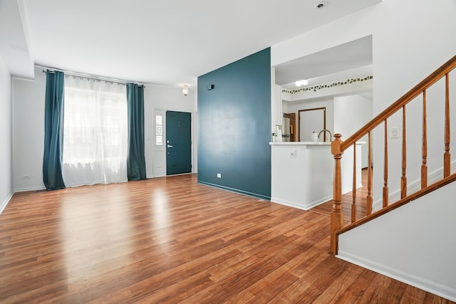 1406 Trescott St, Mundelein, IL 60060 - unfurnished living room featuring wood finished floors, stairway, and baseboards