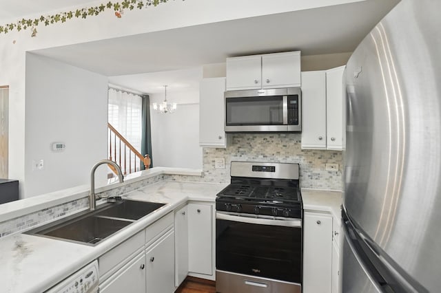 1406 Trescott St, Mundelein, IL 60060 - kitchen featuring stainless steel appliances, a sink, a chandelier, and light countertops