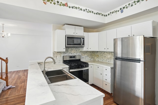 1406 Trescott St, Mundelein, IL 60060 - kitchen with appliances with stainless steel finishes, a sink, dark wood-style floors, tasteful backsplash, and white cabinets